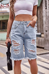 Model showing pockets on Denim ripped bermuda shorts