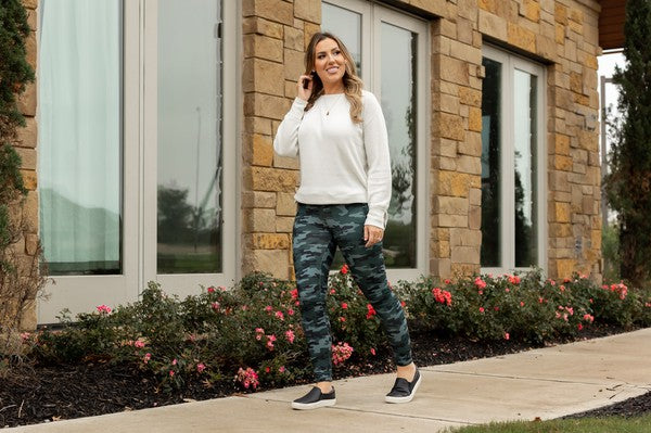 Model walking on sidewalk showing NEW Camo 2.0 Leggings