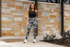 Model with hand in her left pocket of Ace Camo Full Length Leggings