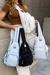 Model carrying five Bekah Convertible Backpack Sling