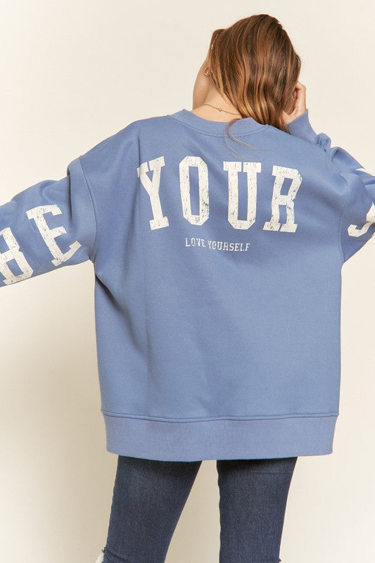 Model showing the letters on the back of Be Yourself Sweatshirt