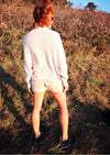 back view of woman outside wearing SWEATER TURTLENECK - KNIT PEARL beige