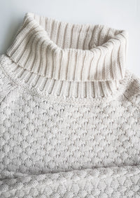 close up front view of SWEATER TURTLENECK - KNIT PEARL beige